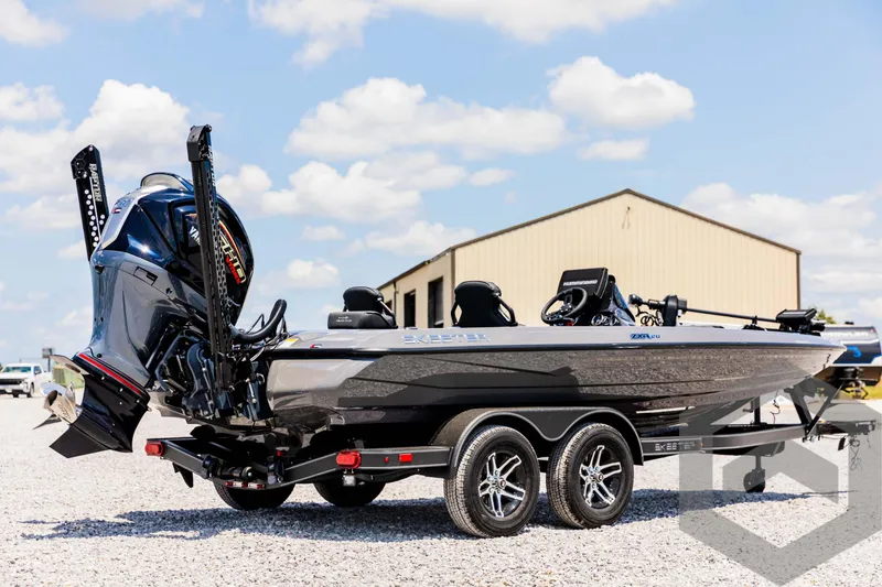 Slide: The Image of 2025 Skeeter ZXR 20 boat on trailer, parked outdoors under a blue sky. - 5