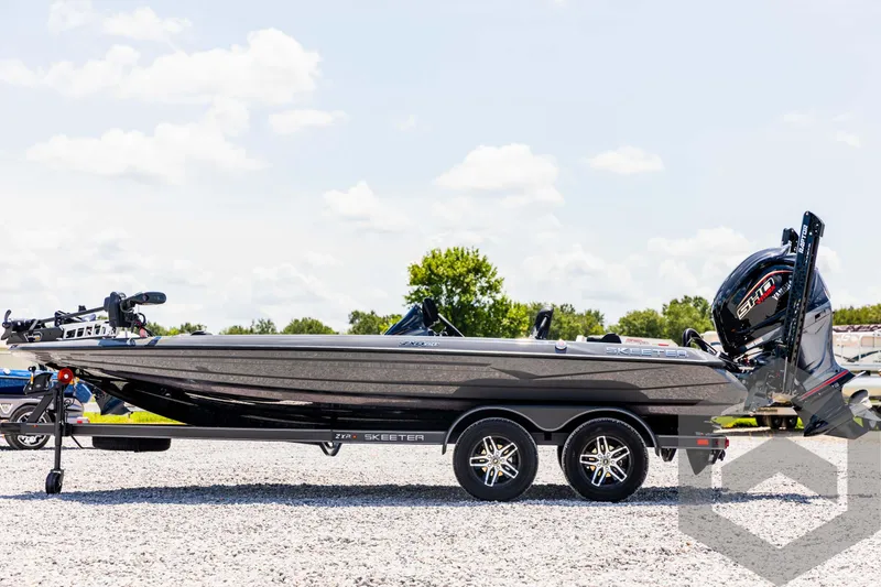 Slide: The Image of 2025 Skeeter ZXR 20 boat on trailer, parked outdoors under a clear sky. - 8