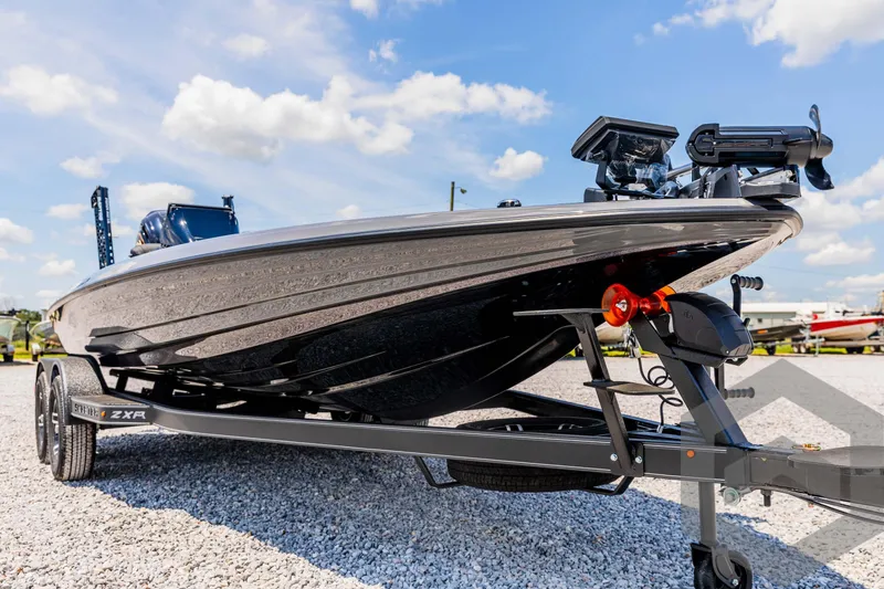 Slide: The Image of 2025 Skeeter ZXR 20 boat on trailer, under a clear blue sky. - 9