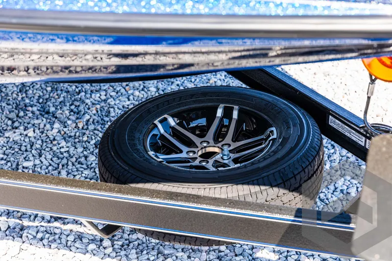 Slide: The Image of Spare tire of a 2025 Skeeter ZXR 21 on gravel surface. - 11