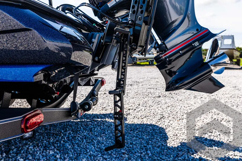 Slide: The Image of 2025 Skeeter ZXR 21 boat motor and trailer on gravel surface. - 21