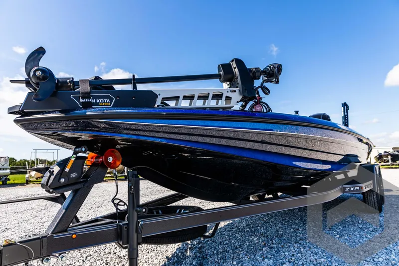 Slide: The Image of 2025 Skeeter ZXR 21 boat on trailer, sleek design, blue and black finish. - 22