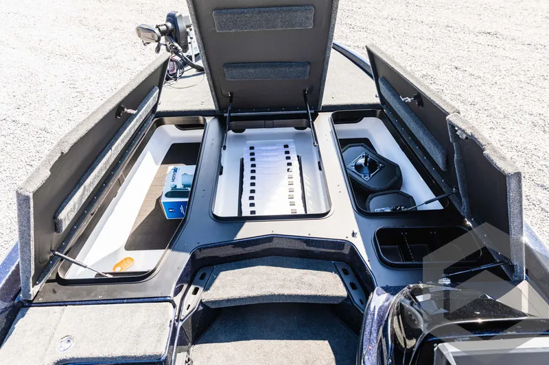 Slide: The Image of 2025 Skeeter ZXR 21 boat storage compartments open, showcasing organized interior layout. - 27