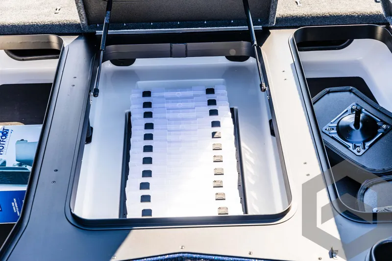 Slide: The Image of Skeeter ZXR 21 boat storage compartment, 2025 model, with organized tackle boxes. - 29