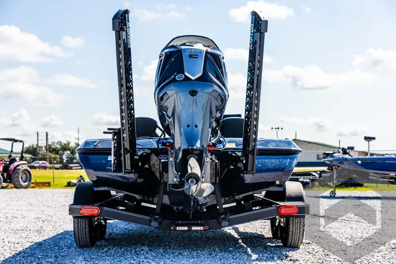 Slide: The Image of 2025 Skeeter ZXR 21 boat on trailer, rear view, outdoors on gravel. - 6