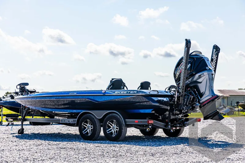 Slide: The Image of 2025 Skeeter ZXR 21 boat on trailer, parked outdoors on gravel. - 7