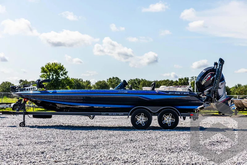 Slide: The Image of 2025 Skeeter ZXR 21 boat on trailer, parked outdoors on gravel. - 8