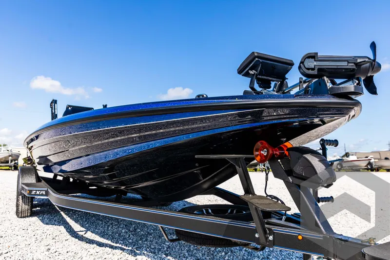 Slide: The Image of 2025 Skeeter ZXR 21 boat on trailer, sleek design, blue sky background. - 9