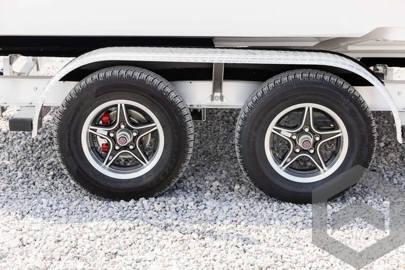 Slide: The Image of 2025 Tidewater 2300 Carolina Bay trailer wheels on gravel surface. - 12