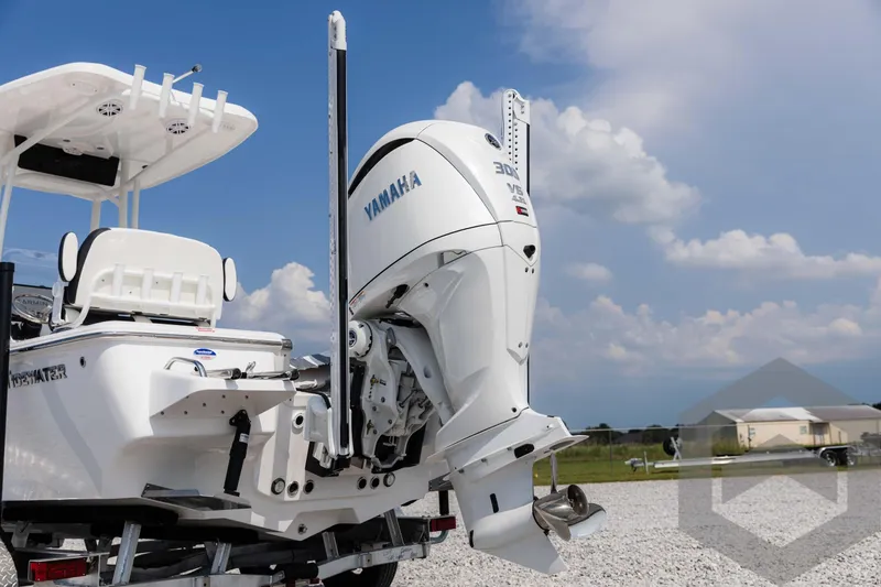 Slide: The Image of 2025 Tidewater 2300 Carolina Bay boat with Yamaha outboard motor, parked on gravel. - 18