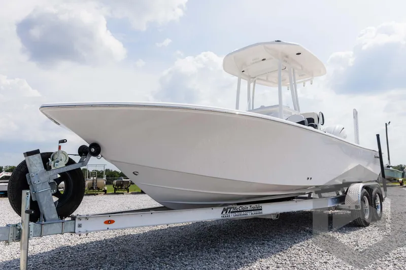 Slide: The Image of 2025 Tidewater 2300 Carolina Bay boat on trailer under cloudy sky. - 22