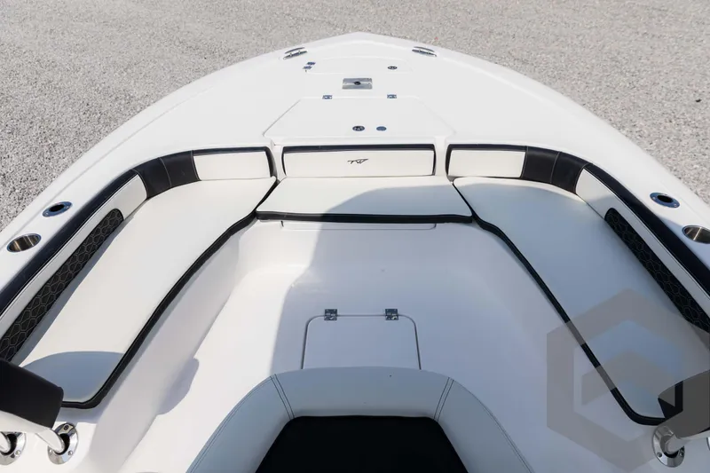 Slide: The Image of 2025 Tidewater 2300 Carolina Bay boat interior with cushioned seating and storage compartments. - 24