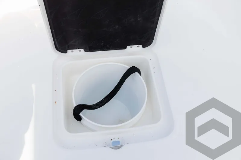 Slide: The Image of Open storage compartment with bucket on 2025 Tidewater 2300 Carolina Bay boat. - 40