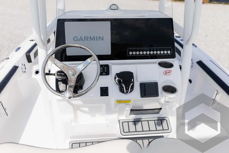 Slide: The Image of 2025 Tidewater 2300 Carolina Bay boat console with Garmin display and steering wheel. - 49