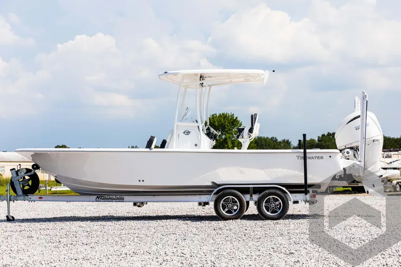 Slide: The Image of 2025 Tidewater 2300 Carolina Bay boat on trailer, parked on gravel lot. - 8
