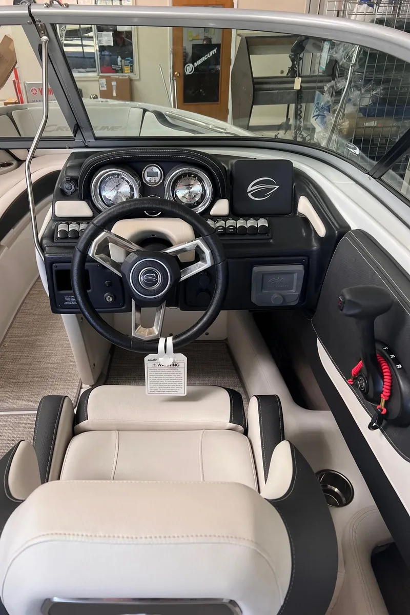 Slide: The Image of 2024 Crownline 210SS boat interior with steering wheel and dashboard controls. - 15