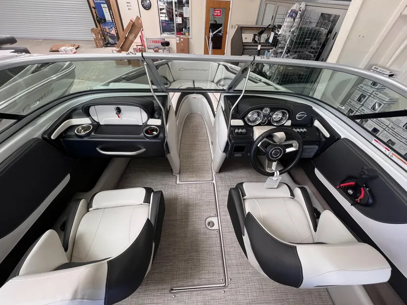 Slide: The Image of 2024 Crownline 210SS boat interior with modern dashboard and seating. - 8