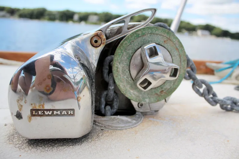 Slide: The Image of Winch on 1978 Tartan 37 sailboat deck with Lewmar branding, near a scenic lake. - 10