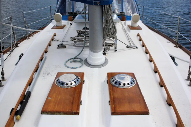 Slide: The Image of Deck of 1978 Tartan 37 sailboat with wooden accents and nautical equipment. - 12