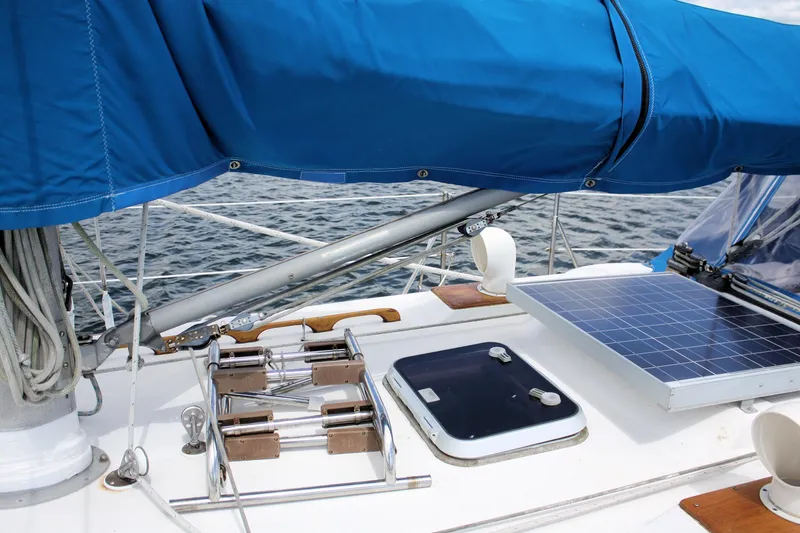 Slide: The Image of 1978 Tartan 37 sailboat deck with blue cover and solar panel. - 13