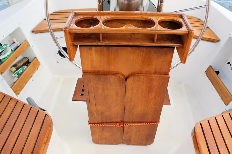 Slide: The Image of 1978 Tartan 37 sailboat cockpit with wooden seating and storage compartments. - 20
