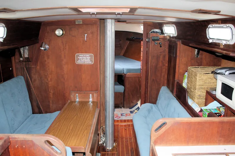Slide: The Image of Interior of a 1978 Tartan 37 sailboat with wooden furnishings and cozy seating. - 26