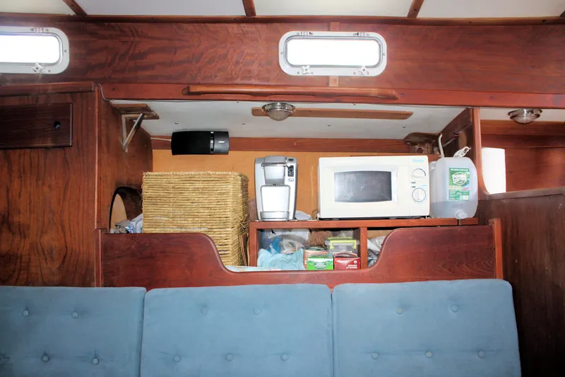 Slide: The Image of 1978 Tartan 37 interior with microwave, coffee maker, and storage basket. - 39