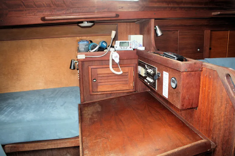 Slide: The Image of 1978 Tartan 37 yacht interior with navigation station and wooden cabinetry. - 41