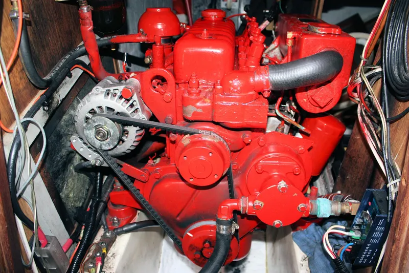 Slide: The Image of Red engine inside a 1978 Tartan 37 sailboat, showcasing mechanical components and wiring. - 43