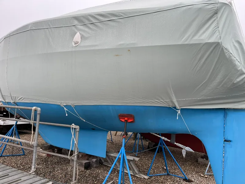 Slide: The Image of 1978 Tartan 37 sailboat covered and supported on stands in a boatyard. - 7