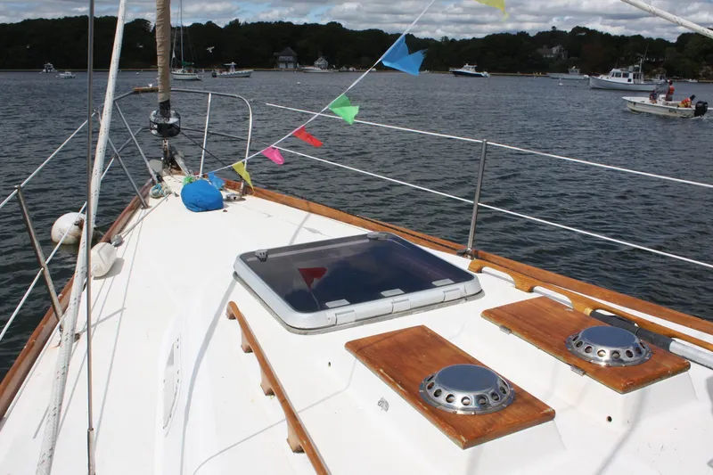 Slide: The Image of Sailboat deck of 1978 Tartan 37 with colorful flags on a calm lake. - 9