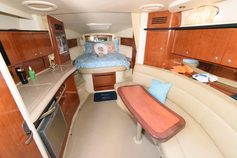 Slide: The Image of Interior of 2006 Sea Ray 320 Sundancer yacht with cozy seating and kitchenette. - 11