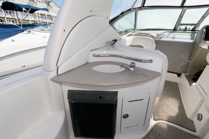 Slide: The Image of 2006 Sea Ray 320 Sundancer boat interior with sink and storage area. - 5