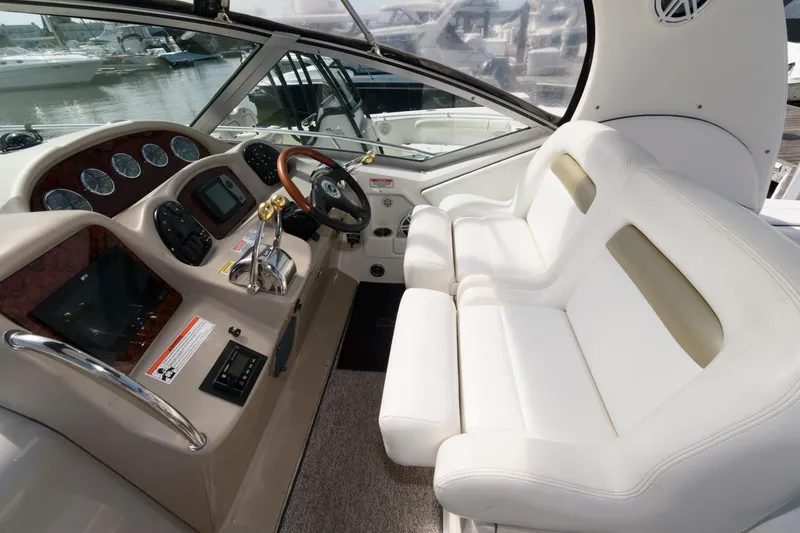 Slide: The Image of Interior of 2006 Sea Ray 320 Sundancer with white seating and control panel. - 6