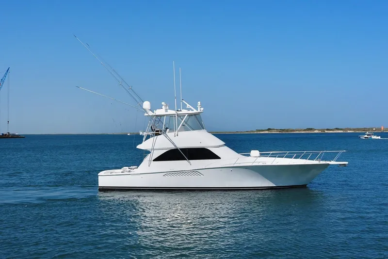 Slide: The Image of 2007 Viking Convertible yacht with mezzanine cruising on calm blue waters. - 0