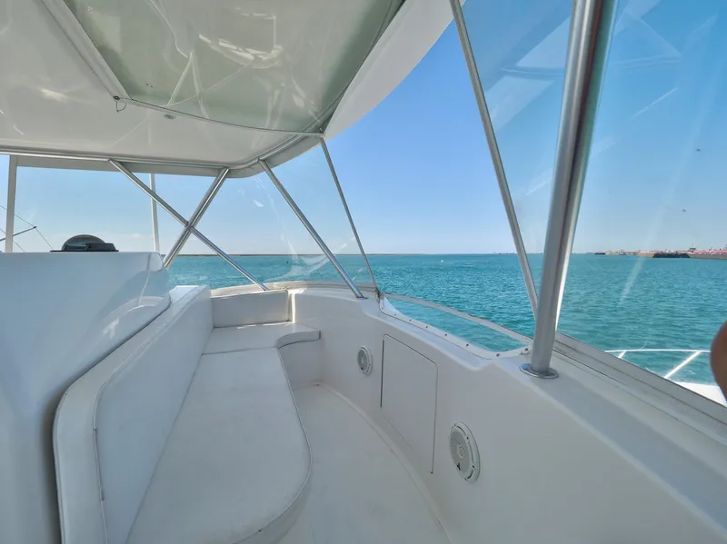 Slide: The Image of 2007 Viking Convertible yacht mezzanine with ocean view and sleek white seating. - 13