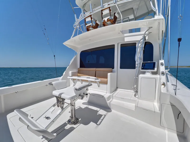 Slide: The Image of 2007 Viking Convertible yacht with mezzanine, featuring spacious deck and seating area. - 15