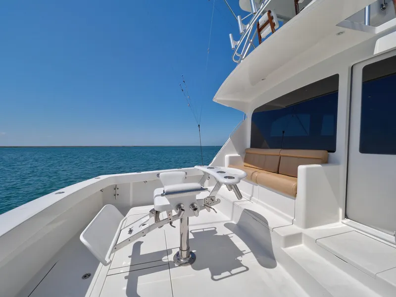 Slide: The Image of 2007 Viking Convertible yacht with mezzanine, featuring spacious deck and ocean view. - 16