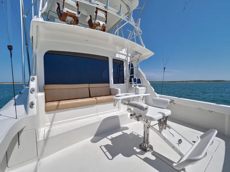 Slide: The Image of 2007 Viking Convertible yacht with mezzanine, featuring spacious deck and seating area. - 17