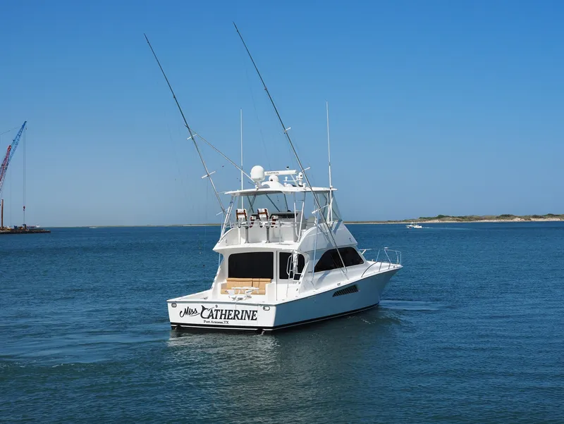 Slide: The Image of 2007 Viking Convertible yacht with mezzanine on calm water, clear blue sky. - 2