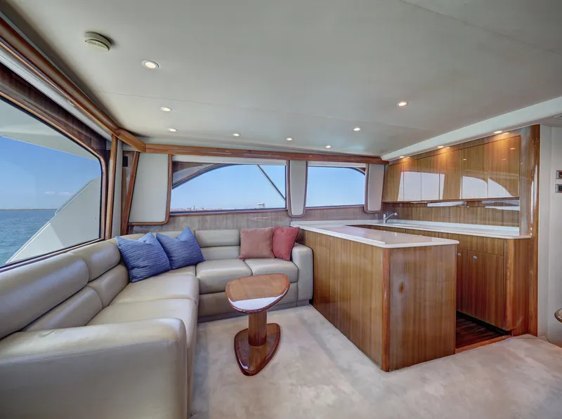 Slide: The Image of Luxurious 2007 Viking Convertible yacht interior with mezzanine, featuring elegant seating and wood finishes. - 20