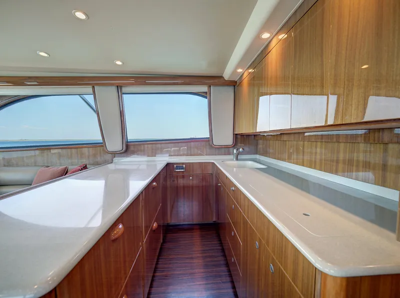 Slide: The Image of Luxurious 2007 Viking Convertible yacht interior with sleek wood cabinetry and spacious countertops. - 25