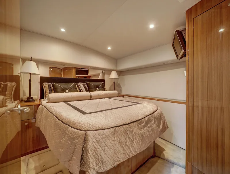 Slide: The Image of Luxurious bedroom in 2007 Viking Convertible yacht with elegant bedding and wood accents. - 29