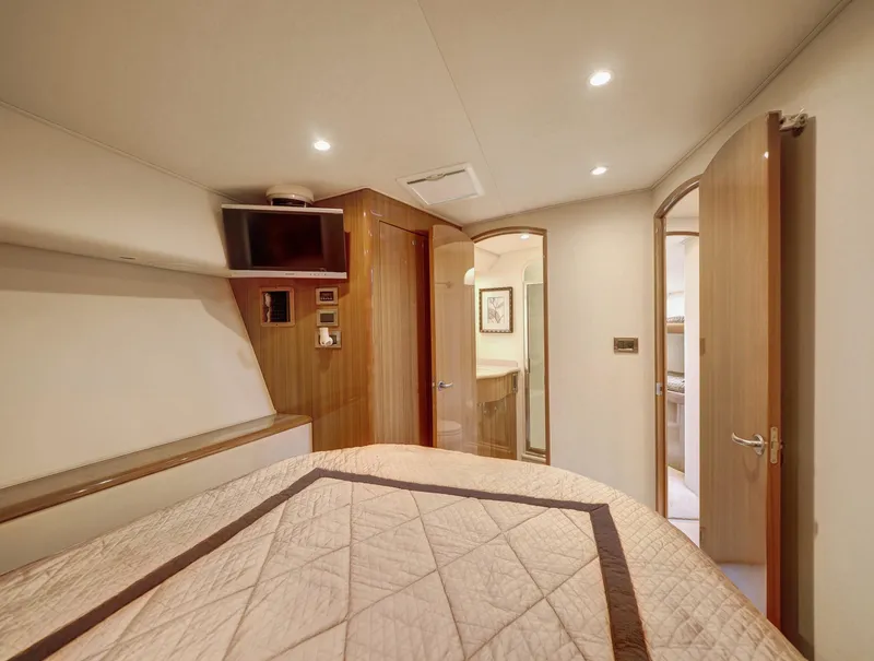 Slide: The Image of Luxurious cabin interior of 2007 Viking Convertible yacht with mezzanine, featuring cozy bedding and modern amenities. - 30