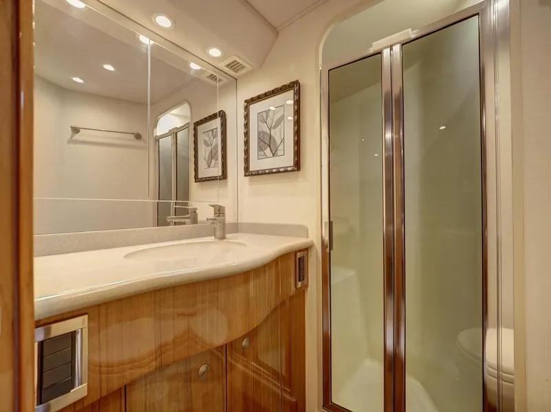 Slide: The Image of Luxurious bathroom in 2007 Viking Convertible yacht with wood cabinetry and glass shower. - 31