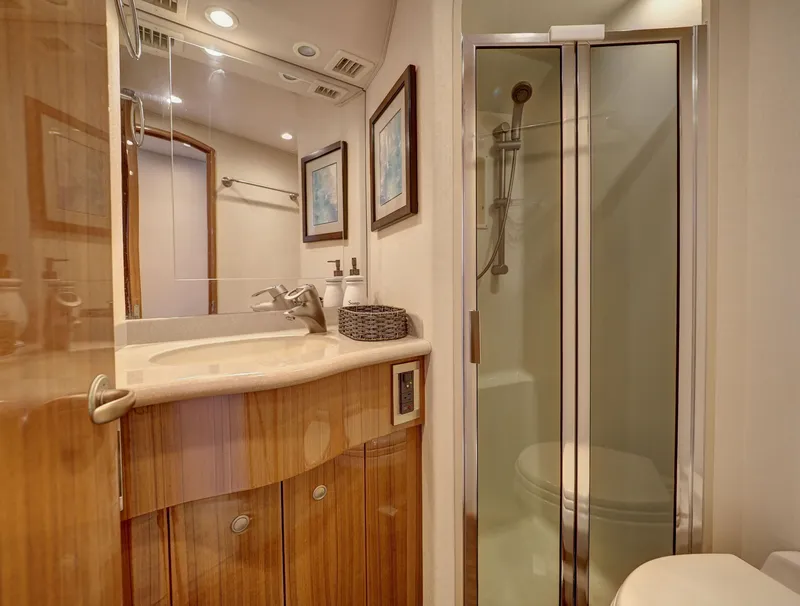 Slide: The Image of Luxurious bathroom in 2007 Viking Convertible yacht with shower and wooden cabinetry. - 34