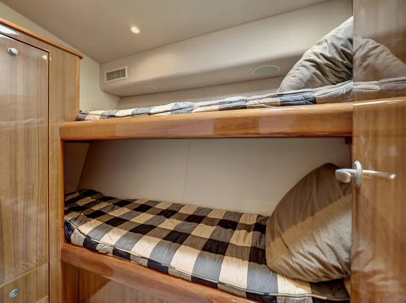 Slide: The Image of Bunk beds in 2007 Viking Convertible yacht cabin with wood finish and checkered bedding. - 35