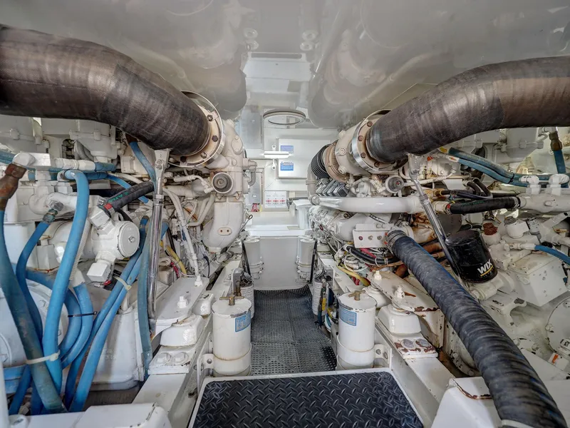 Slide: The Image of Engine room of 2007 Viking Convertible yacht, showcasing complex machinery and piping. - 36