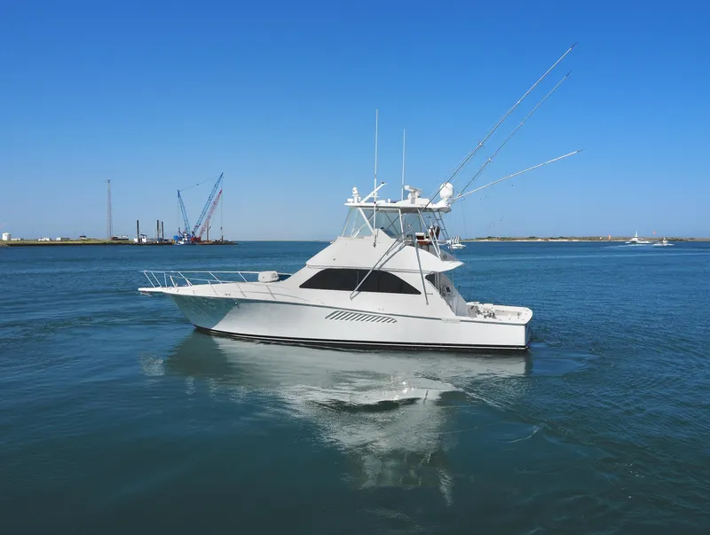 Slide: The Image of 2007 Viking Convertible yacht with mezzanine cruising on calm blue waters. - 4