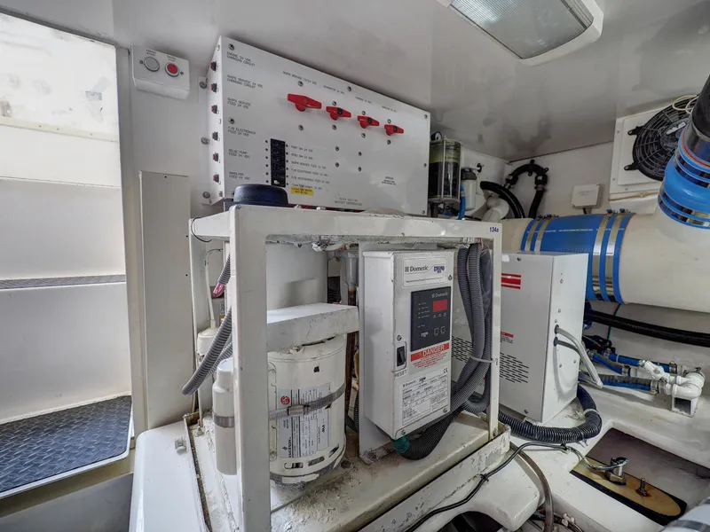 Slide: The Image of Engine room of 2007 Viking Convertible with mezzanine, featuring control panels and equipment. - 43